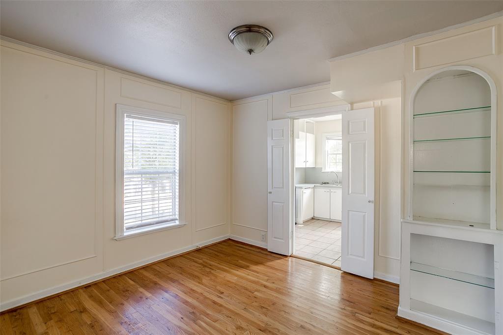 4339 Pershing Avenue Fort Worth, TX 76107 - Photo 4 of 19 an empty room with wooden floor and windows