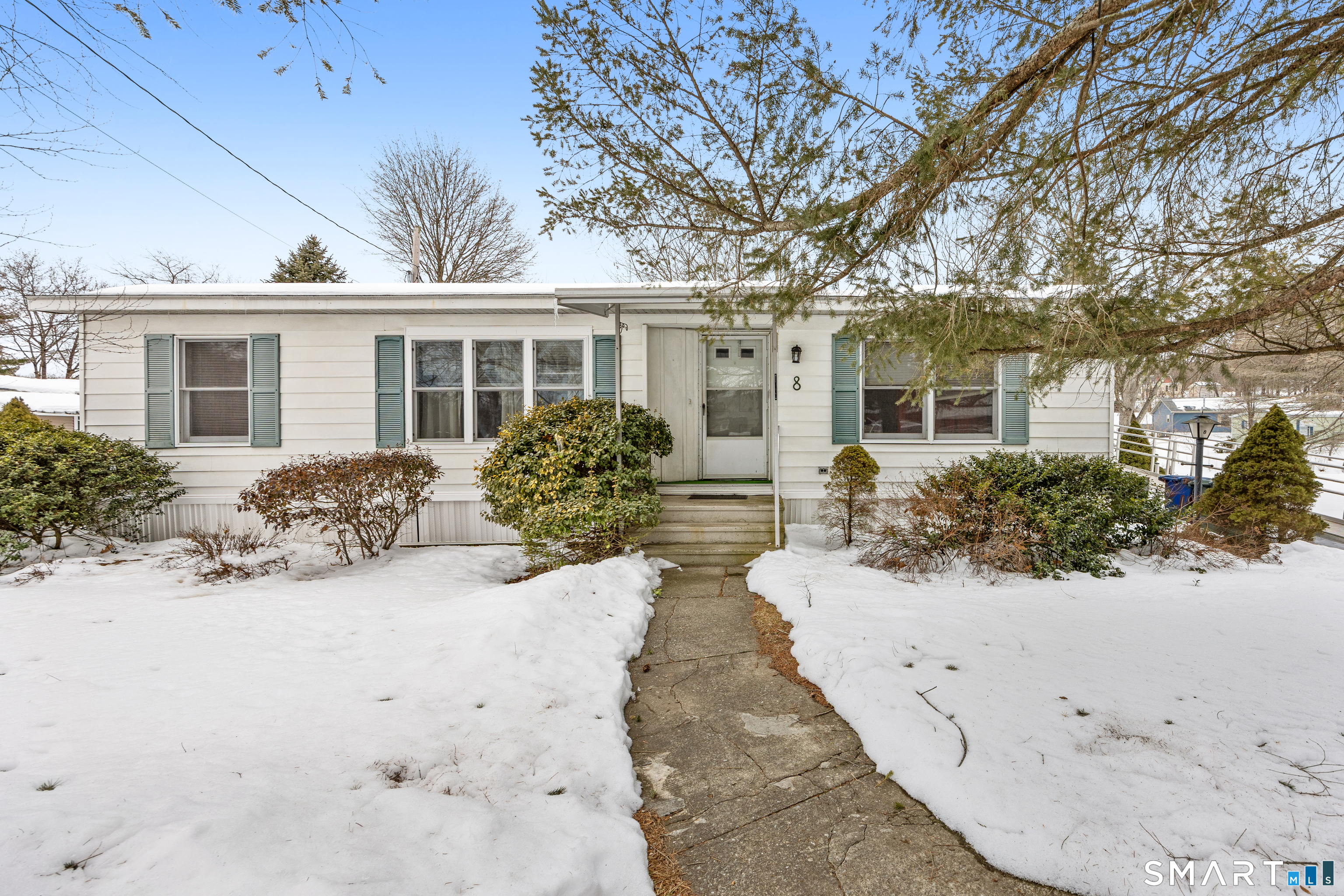 a view of a house with a yard covered in snow