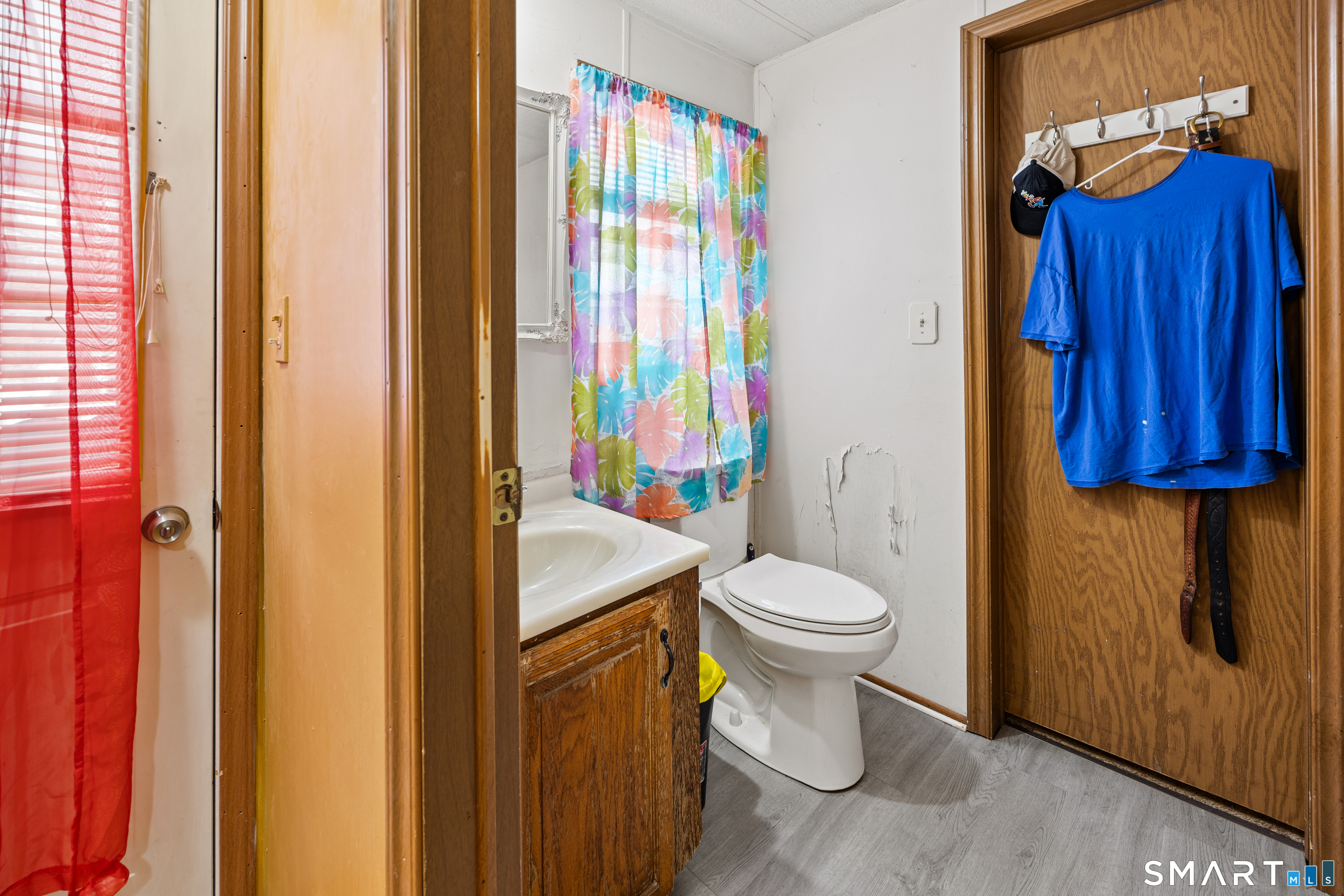 8 Redstone Street Southington, CT 06489 - Photo 16 of 18 a bathroom with a sink a toilet and shower curtain