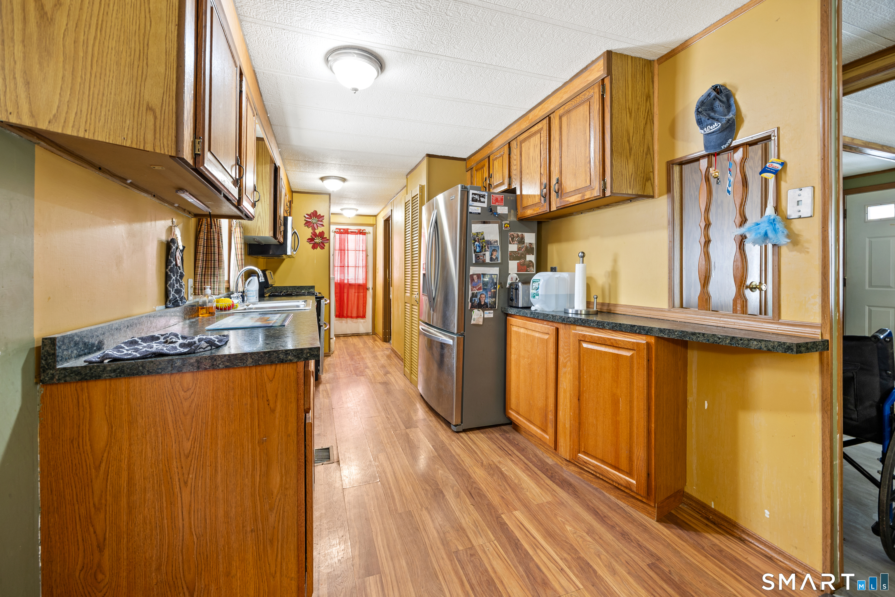 8 Redstone Street Southington, CT 06489 - Photo 6 of 18 a view of a kitchen with stainless steel appliances granite countertop a refrigerator and a stove top oven