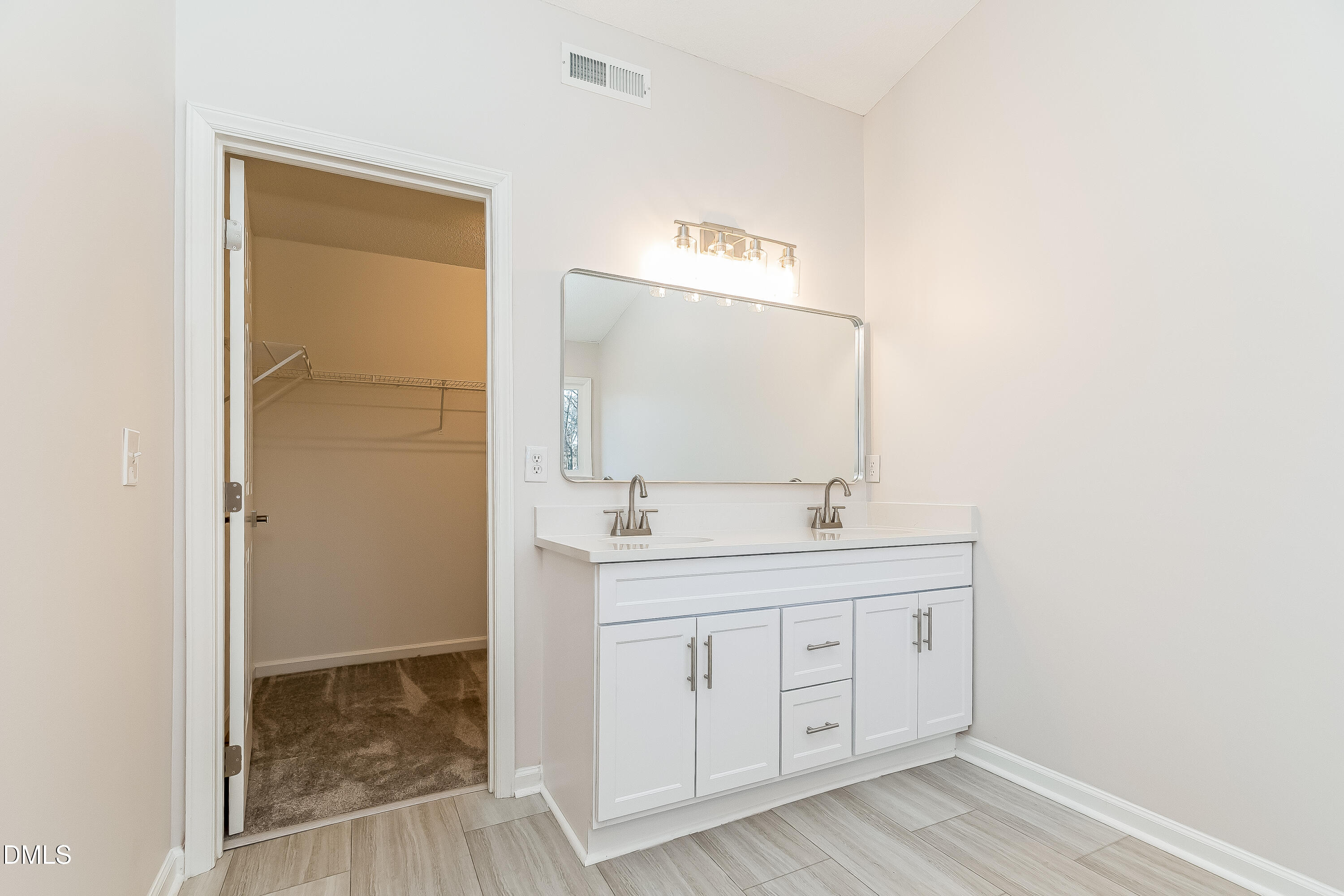6005 Chittim Court Raleigh, NC 27616 - Photo 11 of 19 a bathroom with a granite countertop sink a mirror and a