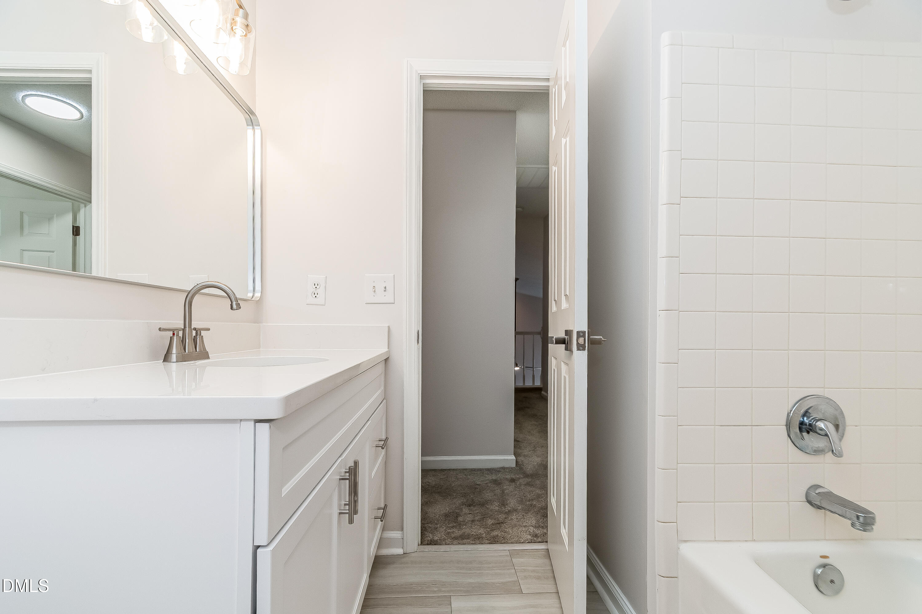 6005 Chittim Court Raleigh, NC 27616 - Photo 18 of 19 a bathroom with a sink a vanity and a tub