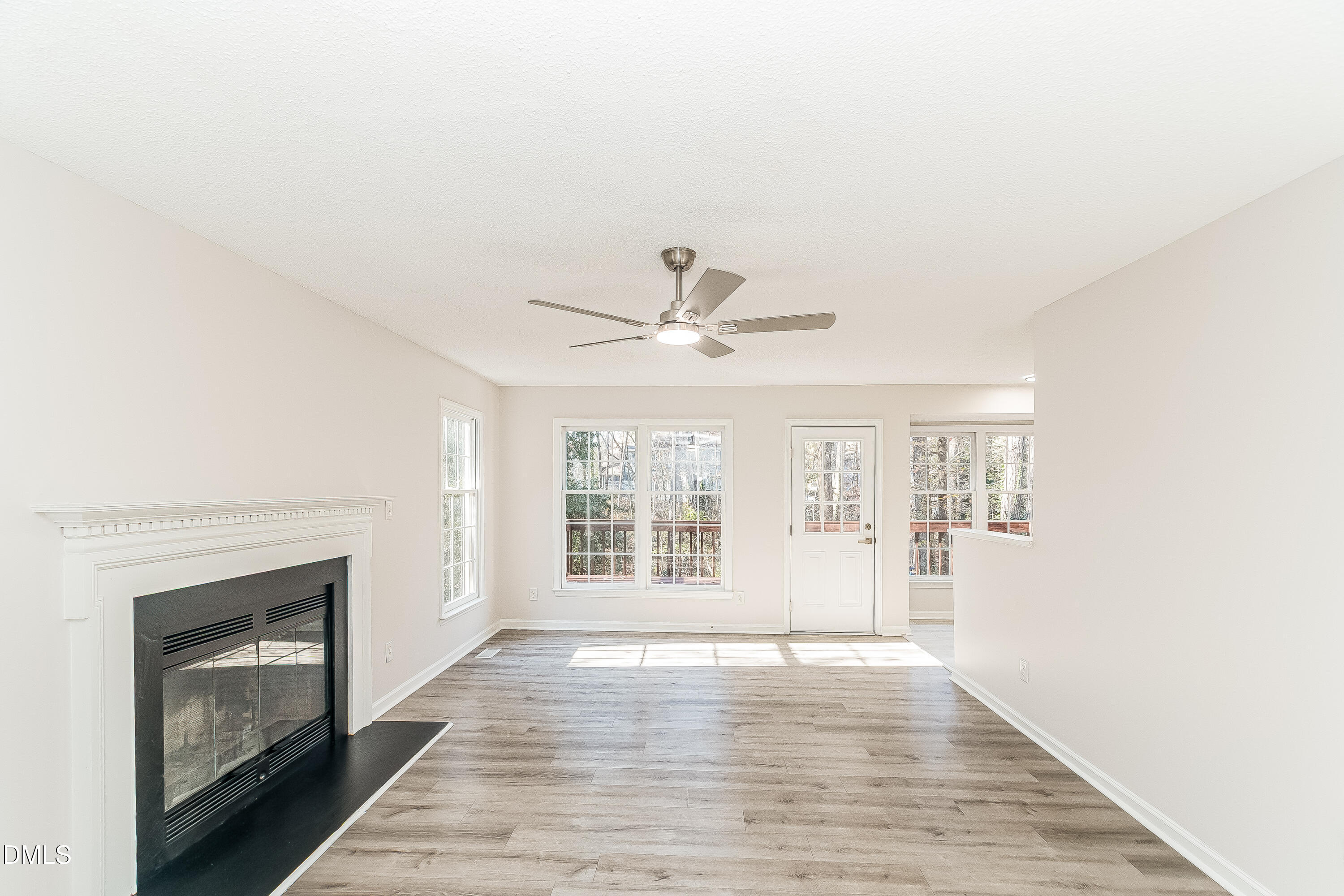 6005 Chittim Court Raleigh, NC 27616 - Photo 2 of 19 a view of an empty room with a fireplace and a window