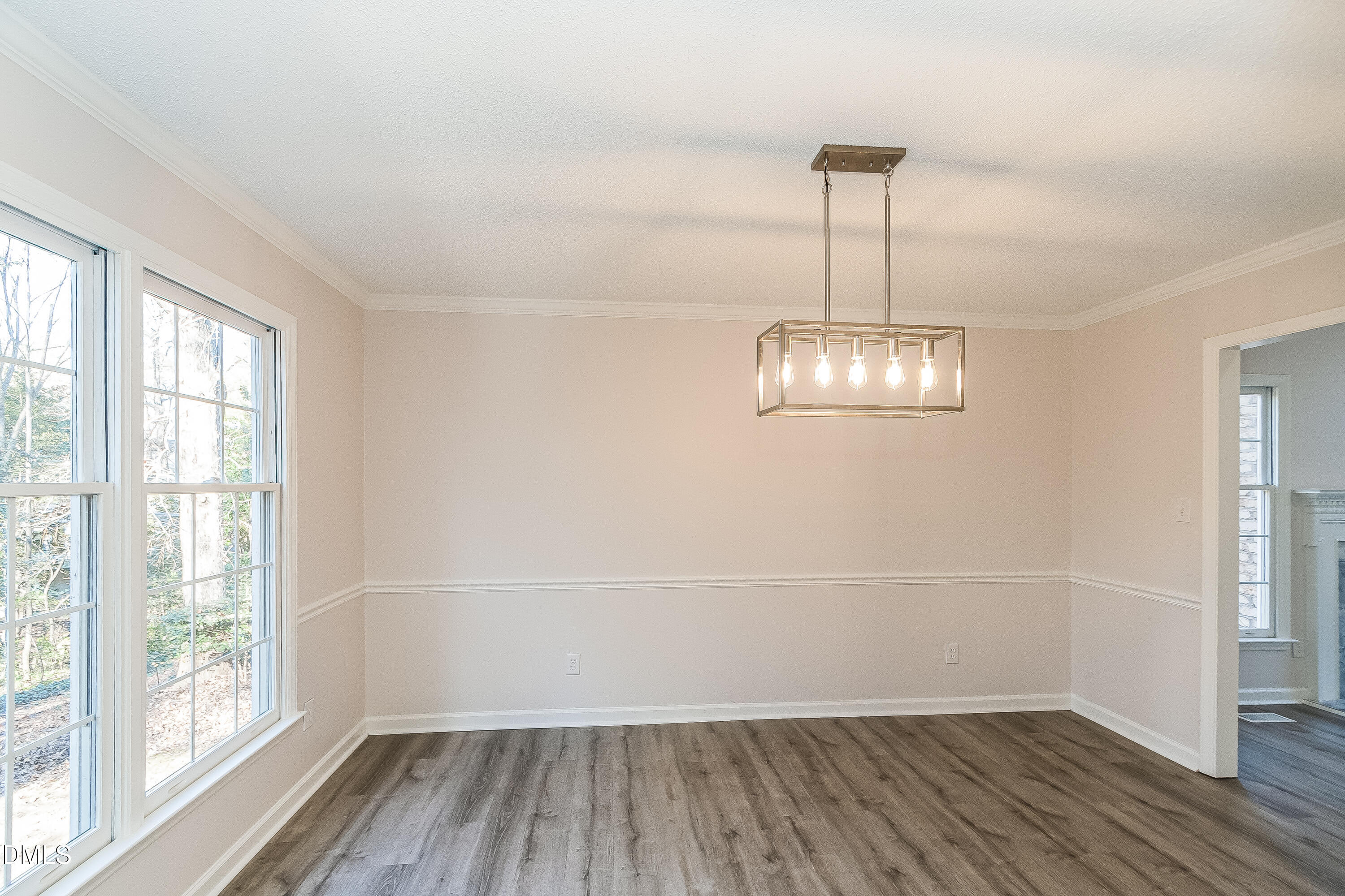 6005 Chittim Court Raleigh, NC 27616 - Photo 5 of 19 an empty room with wooden floor door and windows