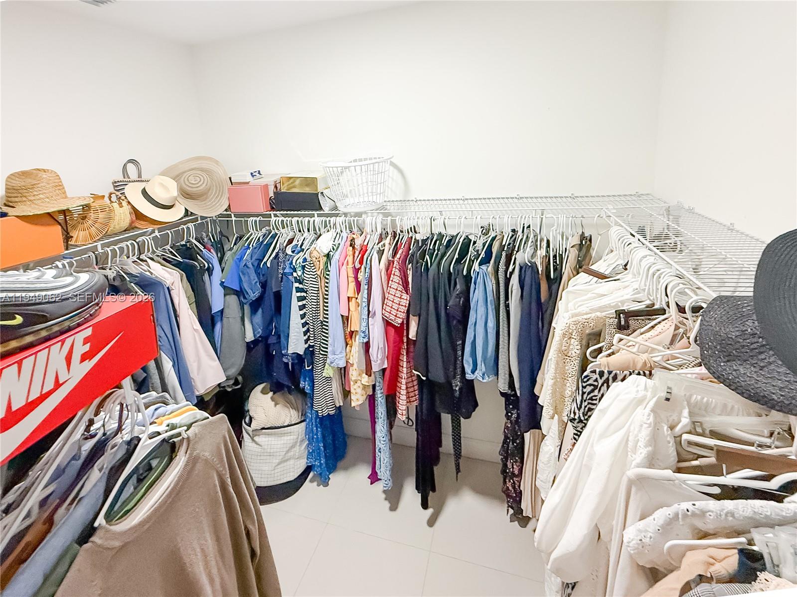 17931 Southwest 152nd Avenue Miami, FL 33187 - Photo 16 of 29 a view of walk in closet with clothes