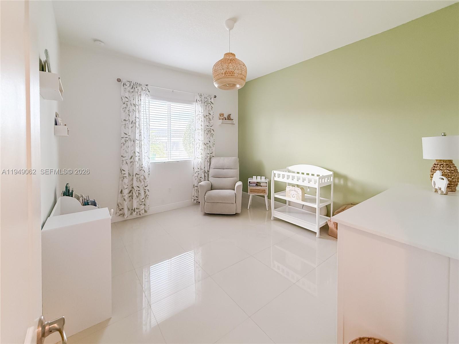 17931 Southwest 152nd Avenue Miami, FL 33187 - Photo 18 of 29 a room with a bed and a chandelier