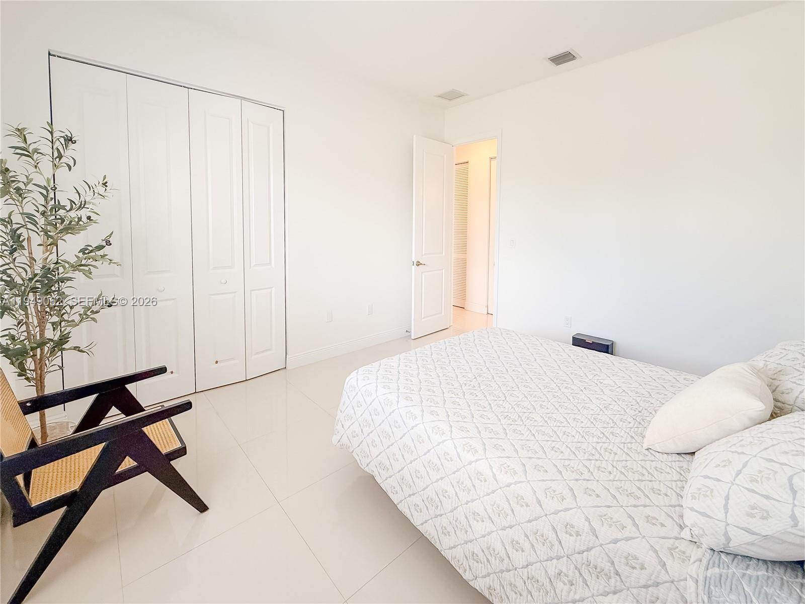 17931 Southwest 152nd Avenue Miami, FL 33187 - Photo 21 of 29 a bedroom with a bed and a chandelier
