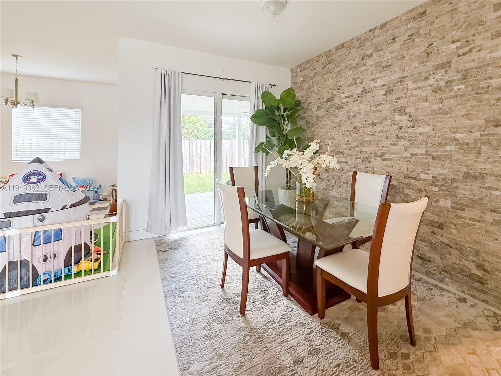 17931 Southwest 152nd Avenue Miami, FL 33187 - Photo 24 of 29 a dining room with furniture and a potted plant