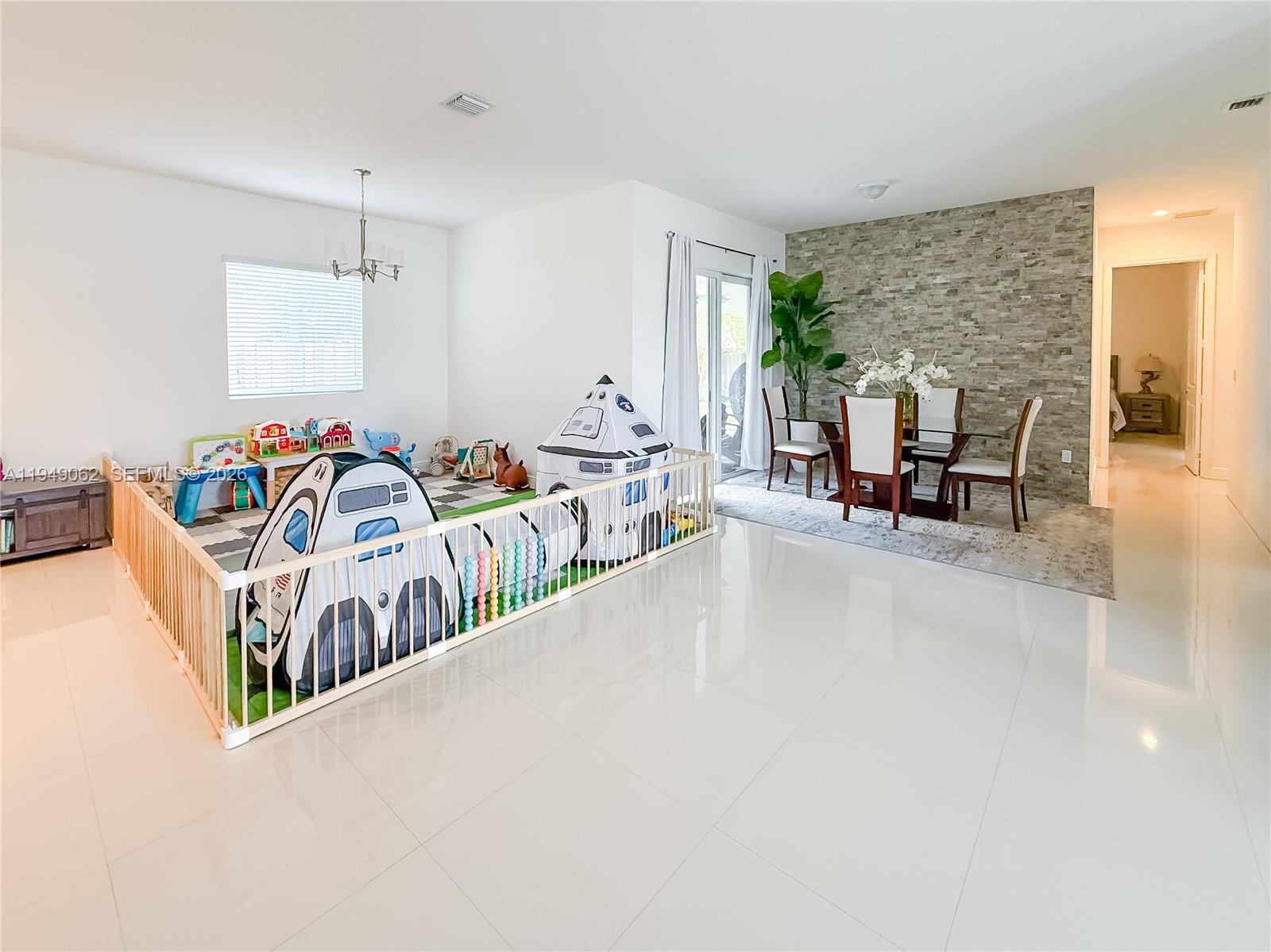 17931 Southwest 152nd Avenue Miami, FL 33187 - Photo 8 of 29 an entryway with a livingroom with furniture