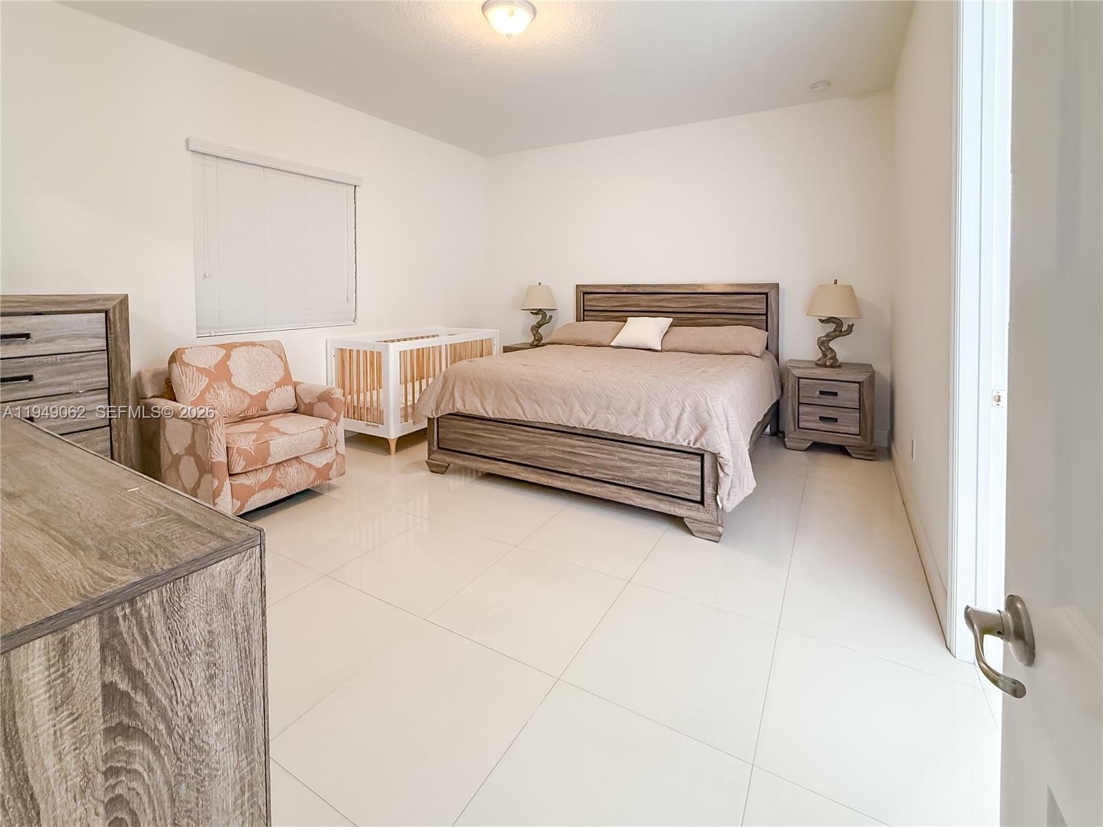 17931 Southwest 152nd Avenue Miami, FL 33187 - Photo 9 of 29 a bedroom with bed and window