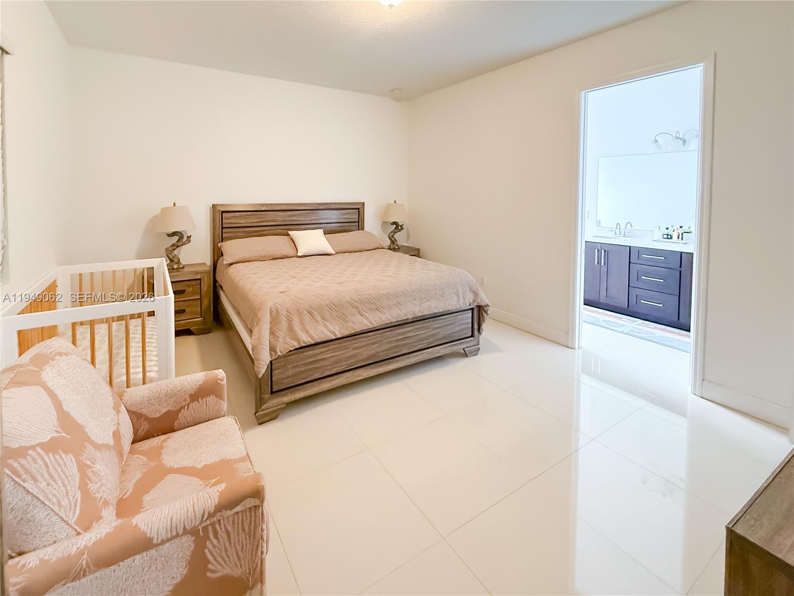 17931 Southwest 152nd Avenue Miami, FL 33187 - Photo 10 of 29 a bedroom with a bed and a couch