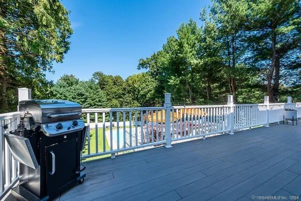 a view of a deck with wooden floor and fence