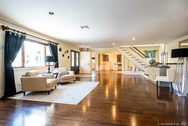 a living room with fireplace furniture and a wooden floor