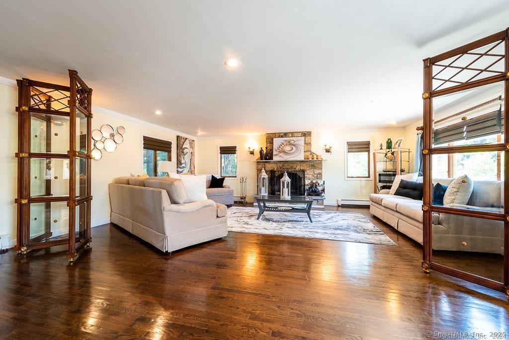 2 Valley Road Westport, CT 06880 - Photo 13 of 21 a living room with fireplace furniture and a wooden floor