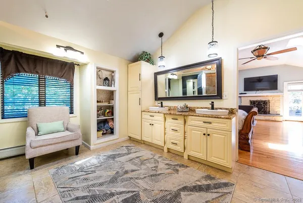 a spacious bedroom with a bed and a flat screen tv