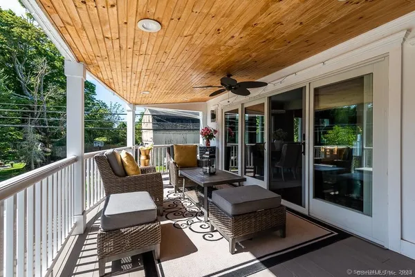 a view of a patio with table and chairs and potted plants