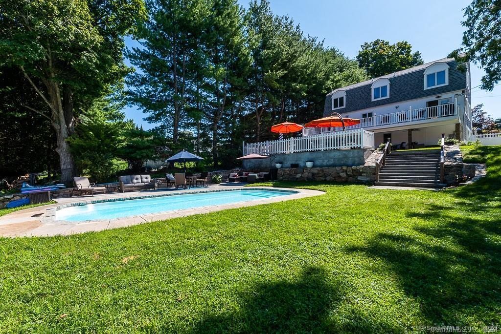 2 Valley Road Westport, CT 06880 - Photo 5 of 21 a view of swimming pool with lawn chairs and a big yard