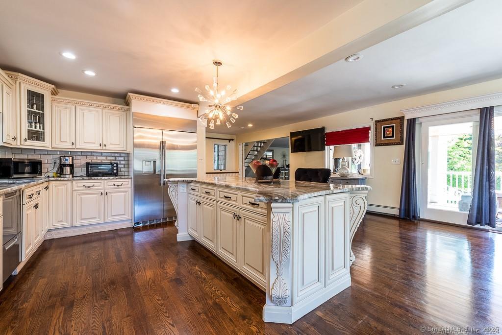 2 Valley Road Westport, CT 06880 - Photo 8 of 21 a open kitchen with stainless steel appliances granite countertop a stove top oven a refrigerator a sink dishwasher and white cabinets with wooden floor