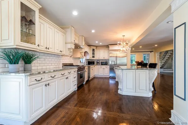 a kitchen with white cabinets and appliances