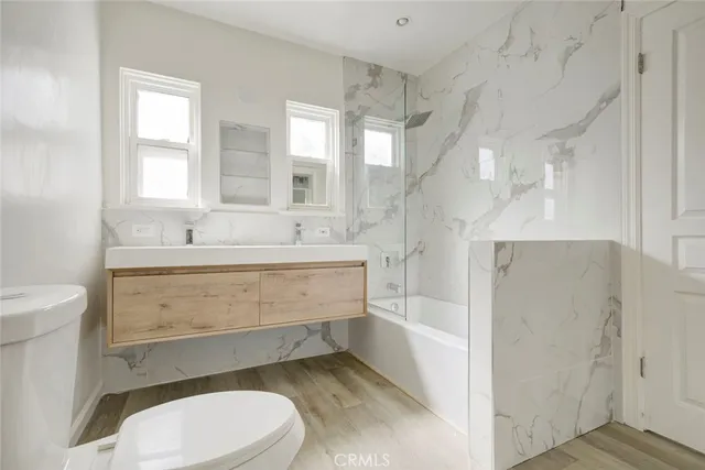 a bathroom with a sink a toilet and bathtub