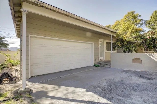 a view of a yard with plants and a slide