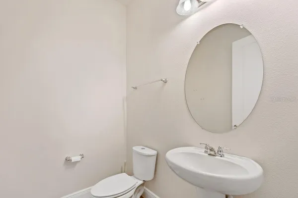 a bathroom with a sink a mirror and a toilet
