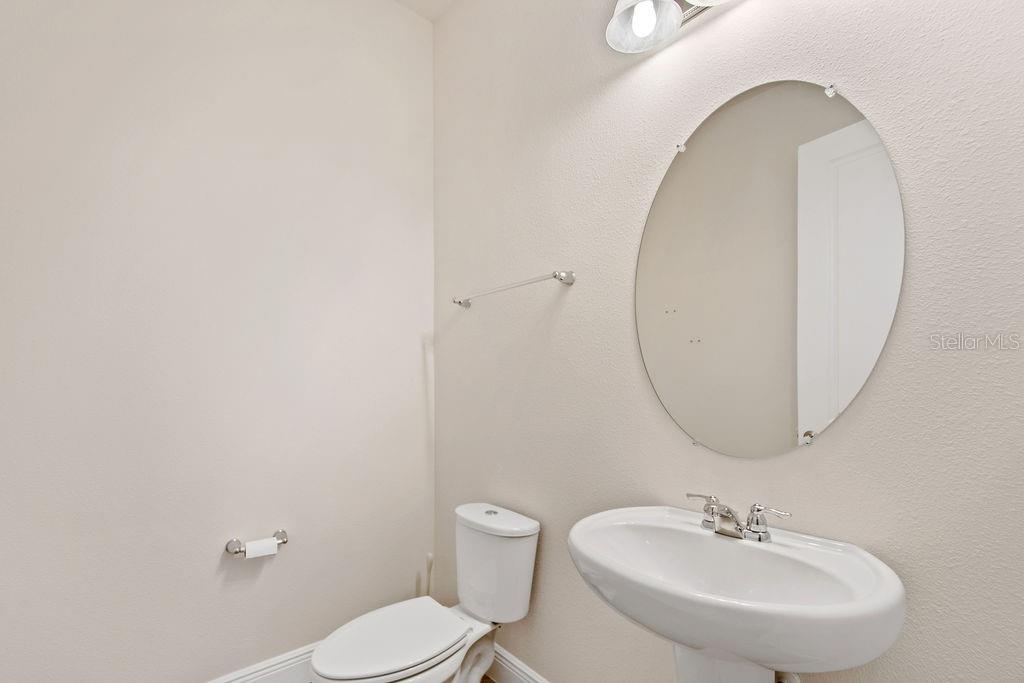 17538 Black Rail Street Windermere, FL 34786 - Photo 12 of 32 a bathroom with a sink a mirror and a toilet
