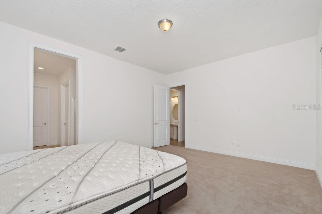 17538 Black Rail Street Windermere, FL 34786 - Photo 14 of 32 a bedroom with a bed and a window
