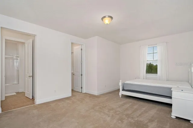 a room with a bed and a window