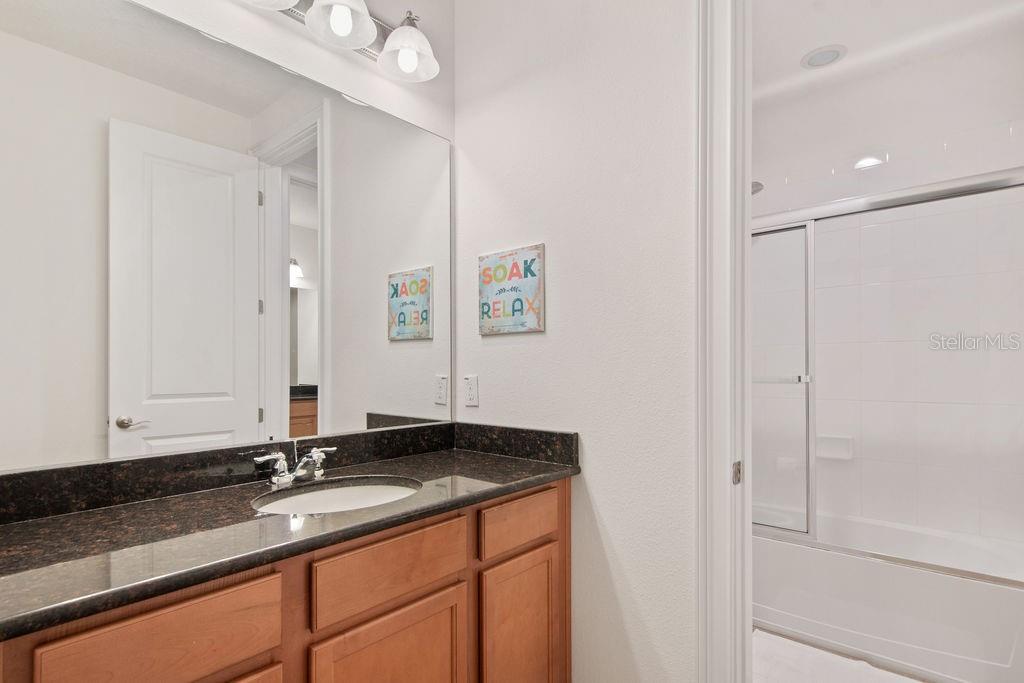 17538 Black Rail Street Windermere, FL 34786 - Photo 19 of 32 a bathroom with a granite countertop sink and a mirror