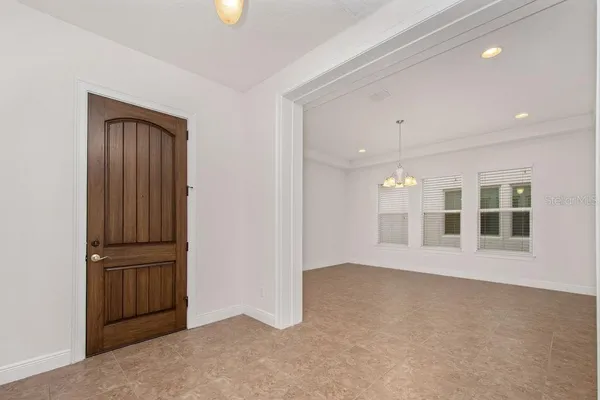 an empty room with windows and entrance