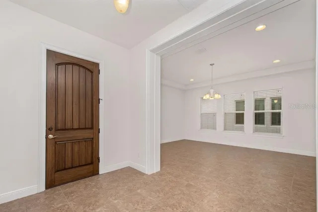 an empty room with windows and entrance