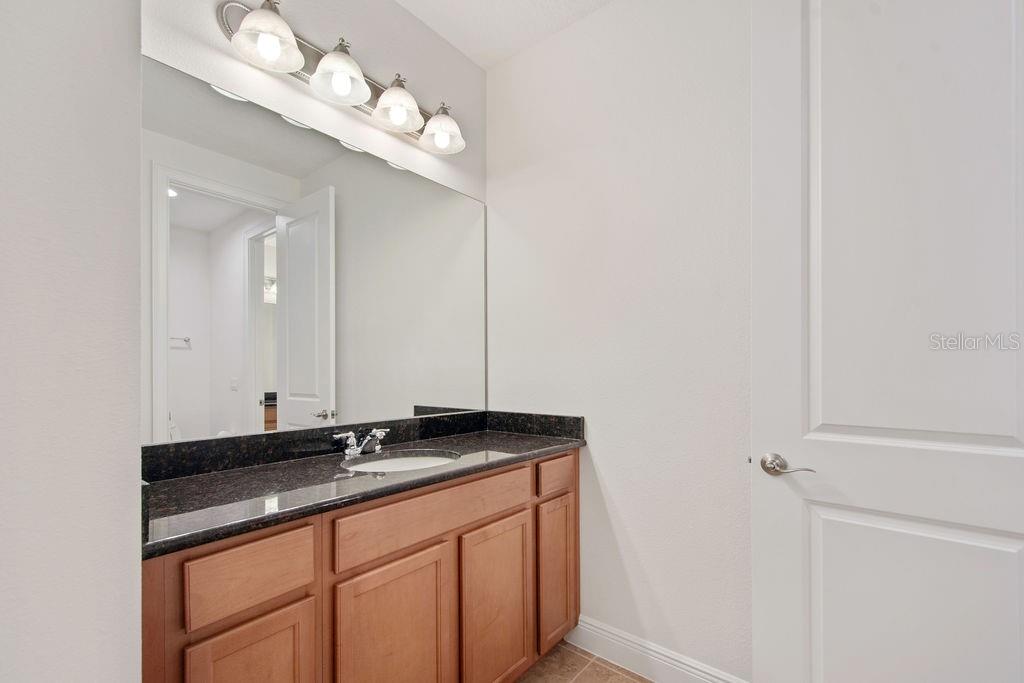 17538 Black Rail Street Windermere, FL 34786 - Photo 21 of 32 a bathroom with a sink and a mirror