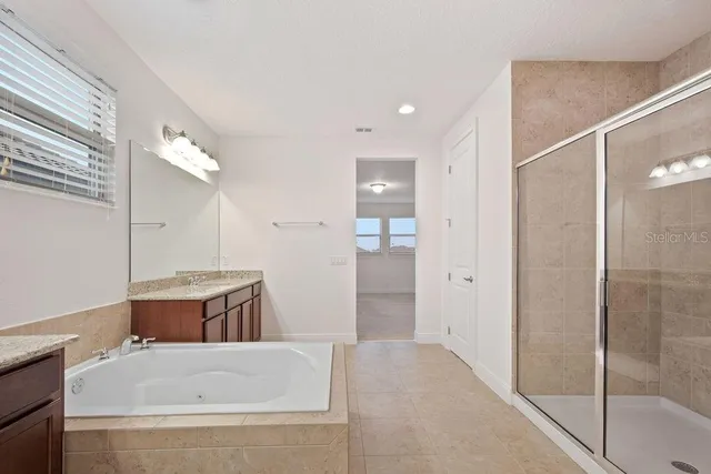 a bathroom with a tub and shower