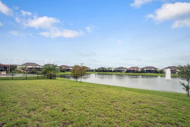 a view of a lake with houses in the back