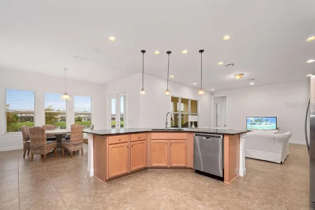 a large kitchen with a large counter top appliances and cabinets