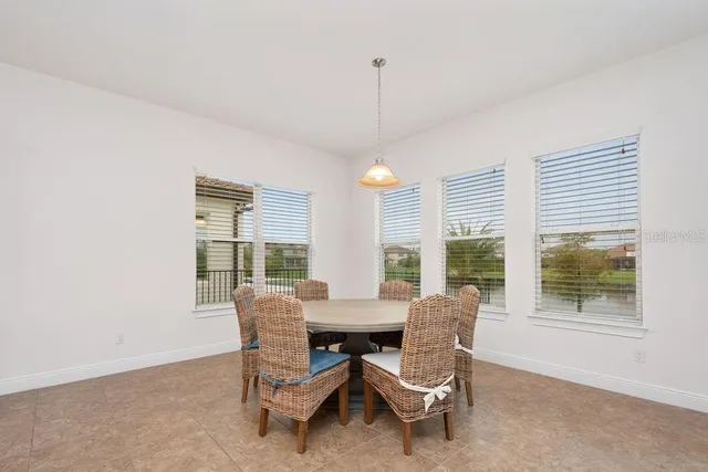 a dining room with furniture and windows