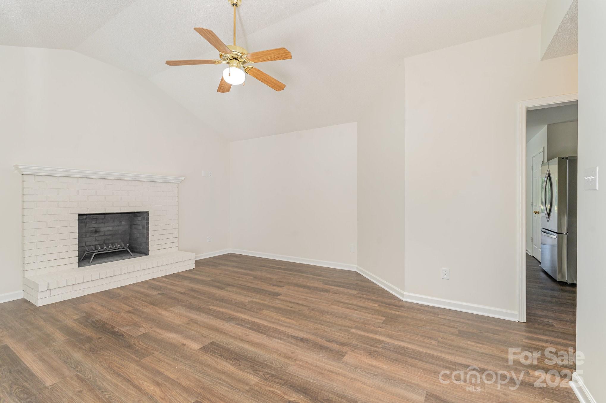 1700 Azalea Avenue Kannapolis, NC 28081 - Photo 6 of 34 a view of an empty room with wooden floor and a fireplace