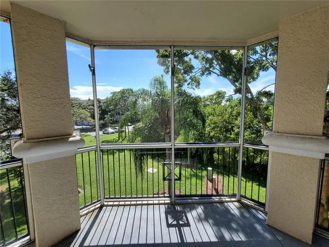 a view of balcony with wooden floor and fence