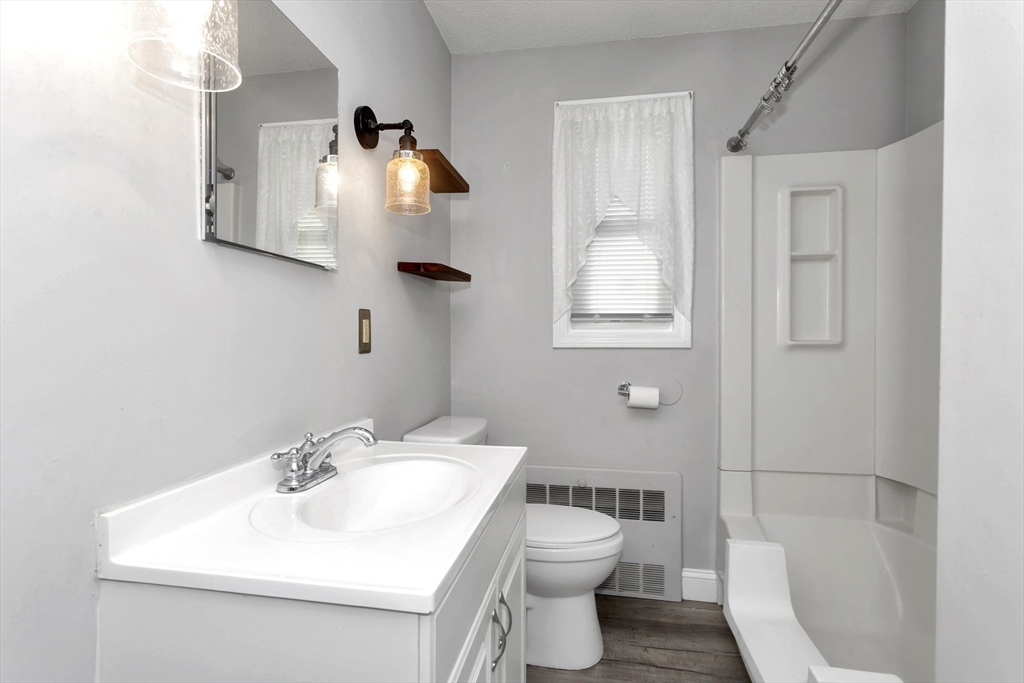 97 Collins Street, Unit 97 Chicopee, MA 01022 - Photo 13 of 21 a bathroom with a sink toilet and mirror