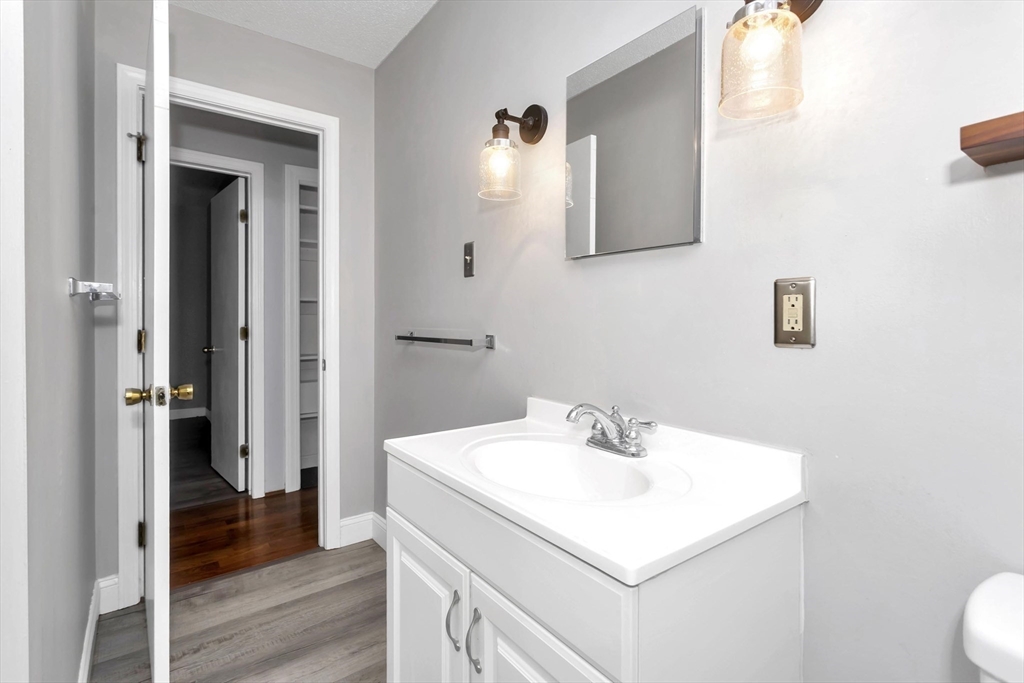 97 Collins Street, Unit 97 Chicopee, MA 01022 - Photo 14 of 21 a bathroom with a sink and a mirror