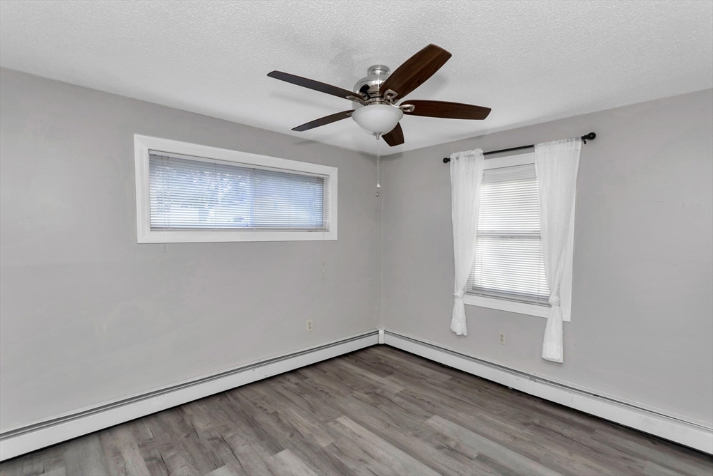 97 Collins Street, Unit 97 Chicopee, MA 01022 - Photo 17 of 21 a view of empty room with wooden floor and fan