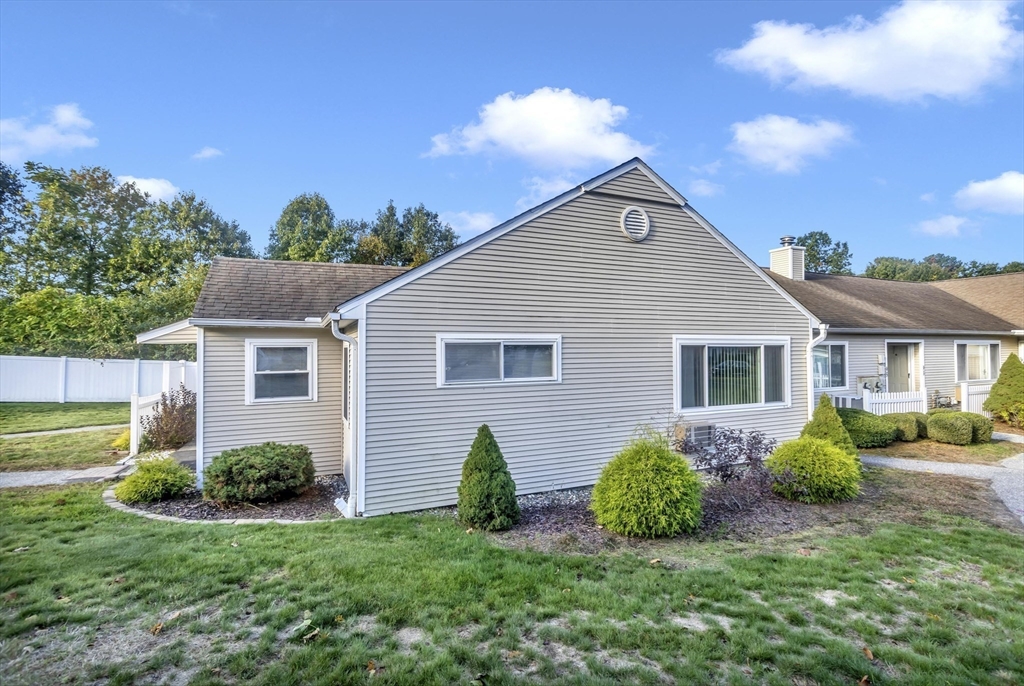 97 Collins Street, Unit 97 Chicopee, MA 01022 - Photo 3 of 21 a view of a house with a yard and plants