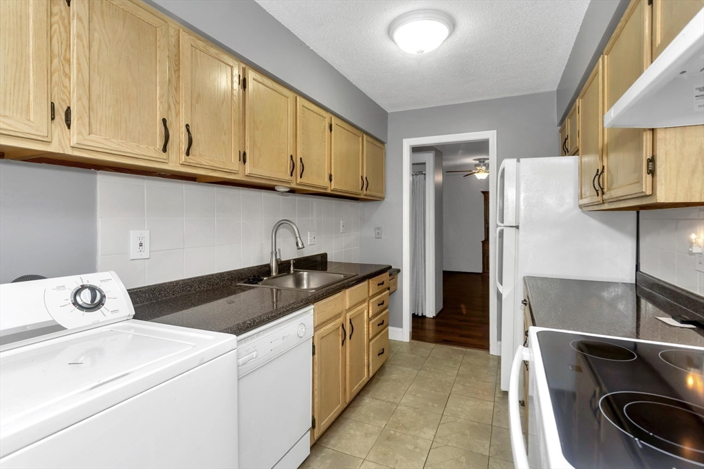 97 Collins Street, Unit 97 Chicopee, MA 01022 - Photo 6 of 21 a kitchen with a sink stove and refrigerator