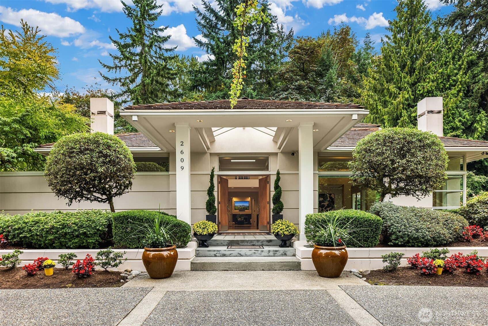 2609 Evergreen Point Road Medina, WA 98039 - Photo 19 of 39 a front view of a house with lots of potted plants