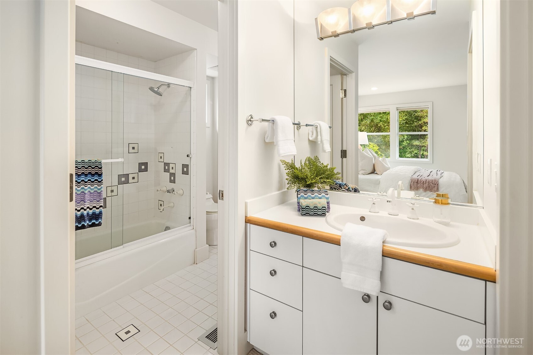 2609 Evergreen Point Road Medina, WA 98039 - Photo 30 of 39 a bathroom with a shower sink and mirror