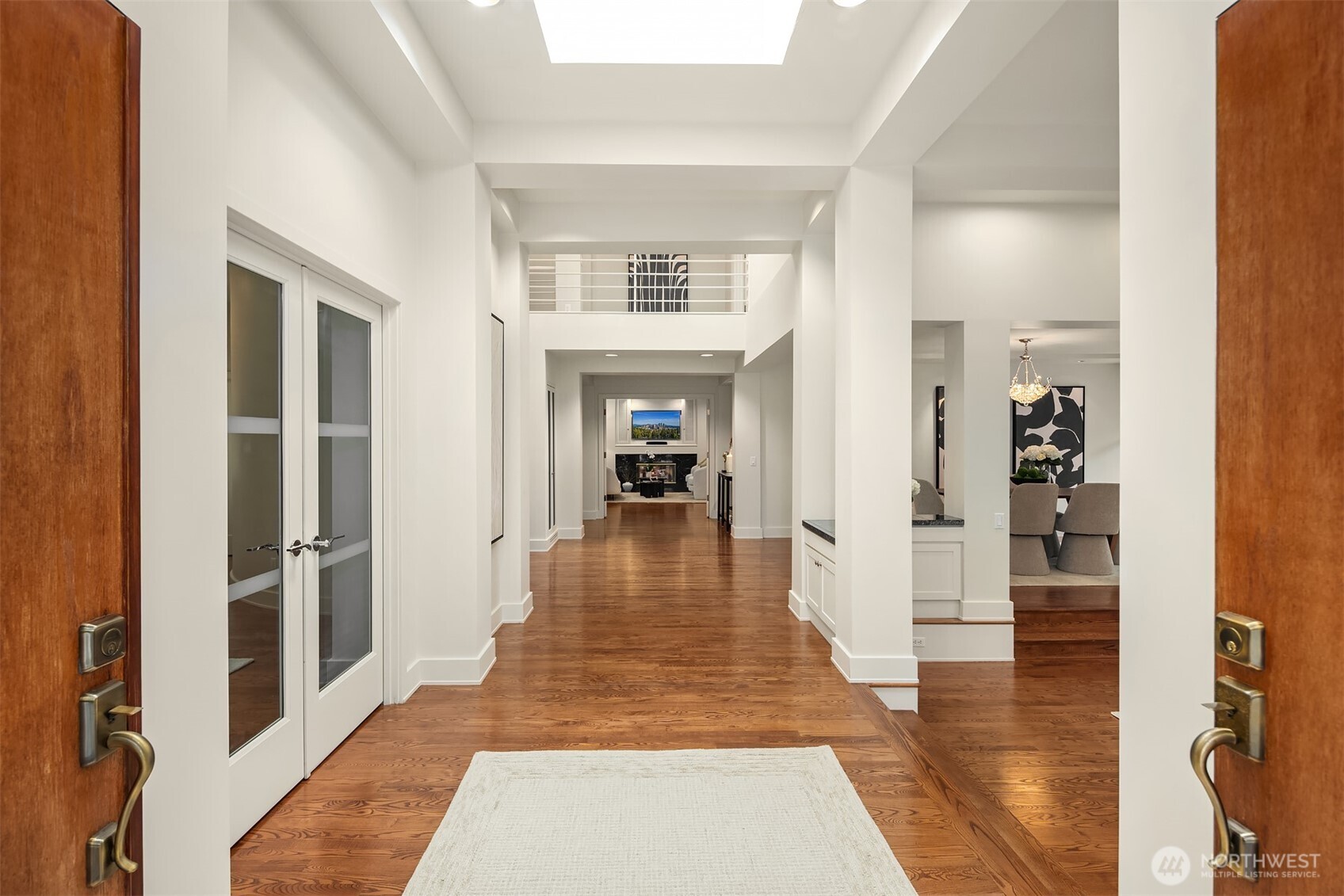 2609 Evergreen Point Road Medina, WA 98039 - Photo 6 of 39 a hallway with wooden floor fireplace and living room