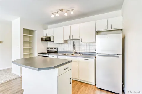 an empty room with a stove and a window