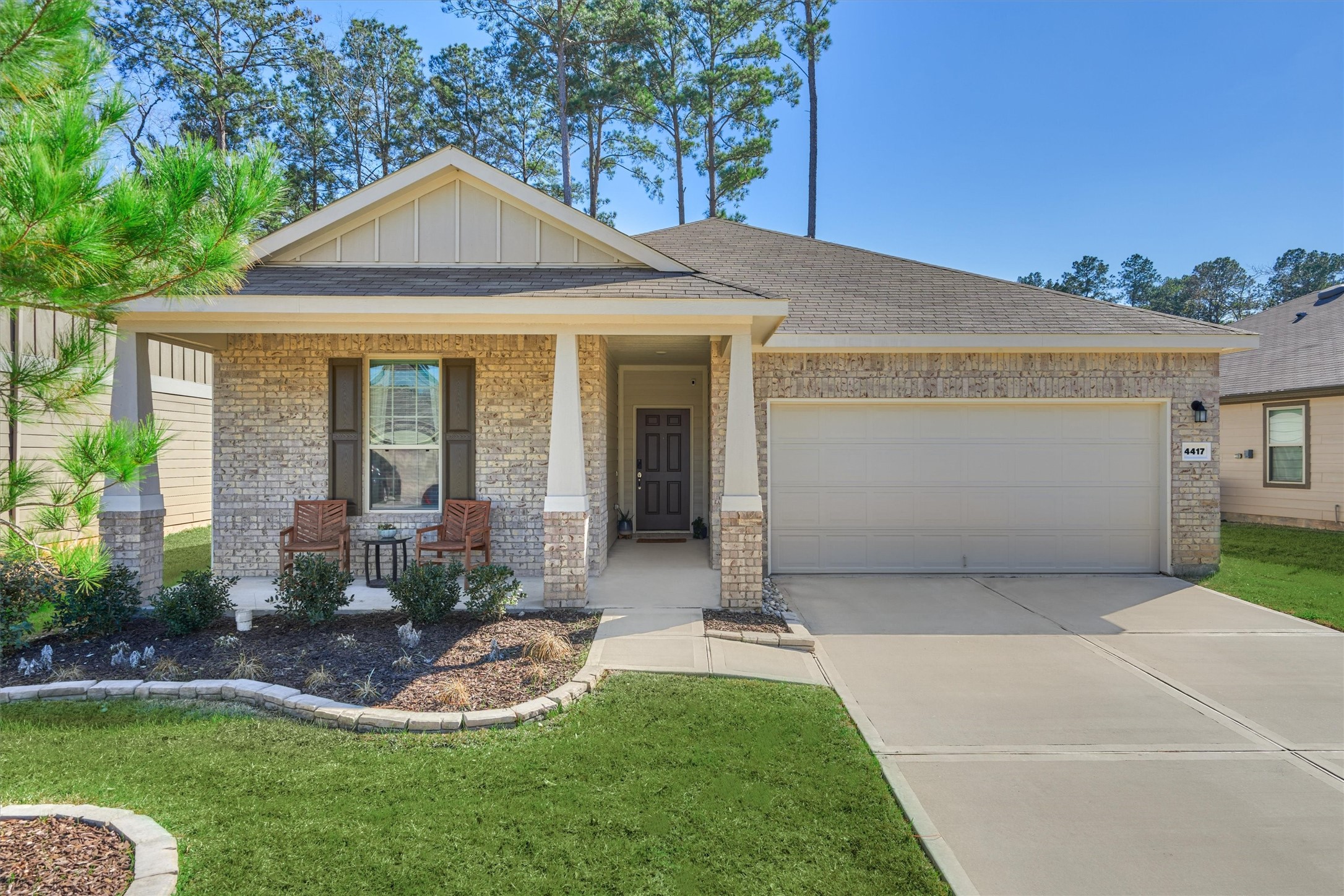 4417 Longleaf Timbers Court Conroe, TX 77304 - Photo 1 of 30 a front view of a house with a yard and porch