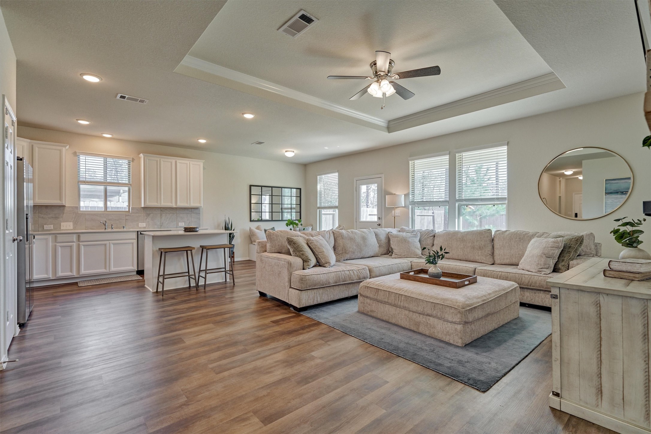 4417 Longleaf Timbers Court Conroe, TX 77304 - Photo 15 of 30 a living room with furniture kitchen view and a wooden floor